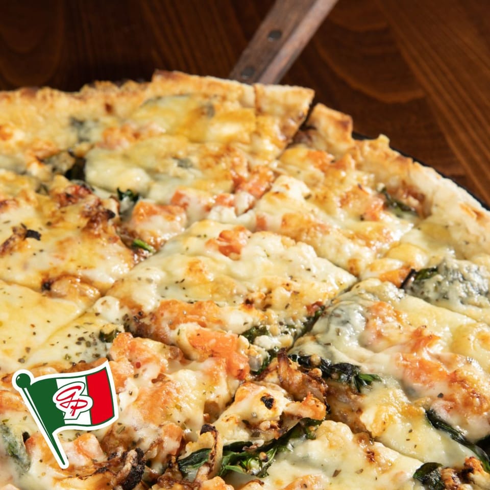Close-up of a Gelsosomo's Pizzeria pizza, topped with melted cheese, shrimp, and spinach.